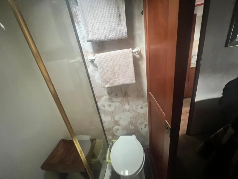 Slide: The Image of Bathroom interior of 1996 Ocean Yachts 48 Super Sport with towels and toilet. - 27