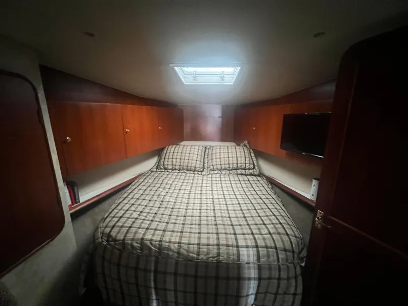 Slide: The Image of Interior cabin of 1996 Ocean Yachts 48 Super Sport with bed and wooden cabinets. - 28