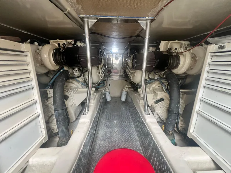 Slide: The Image of Engine room of 1996 Ocean Yachts 48 Super Sport, featuring dual engines and mechanical components. - 30
