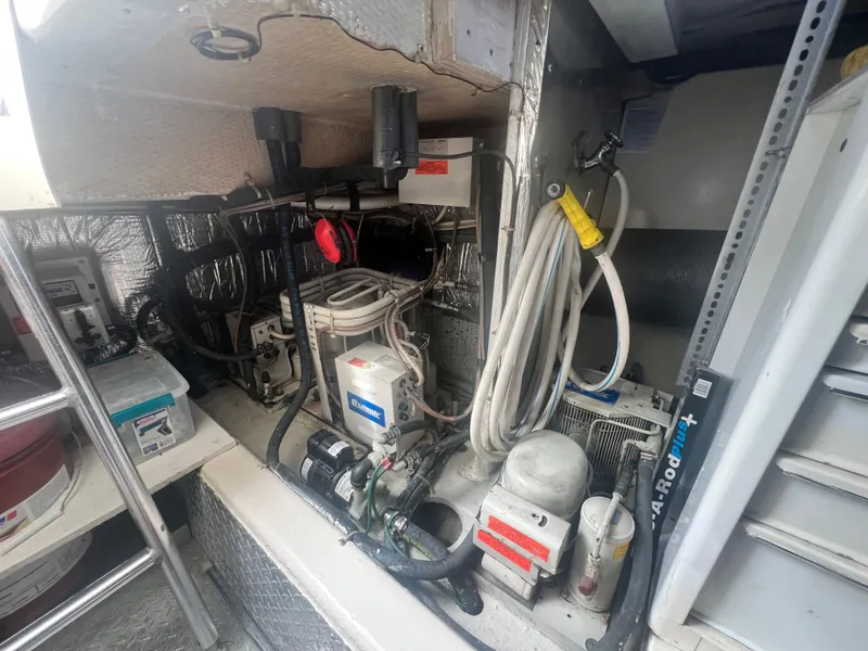 Slide: The Image of Engine room of a 1996 Ocean Yachts 48 Super Sport, showcasing mechanical components and wiring. - 31