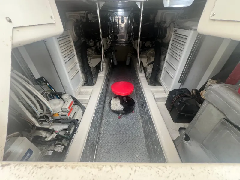 Slide: The Image of Engine room of 1996 Ocean Yachts 48 Super Sport, featuring dual engines and equipment. - 32