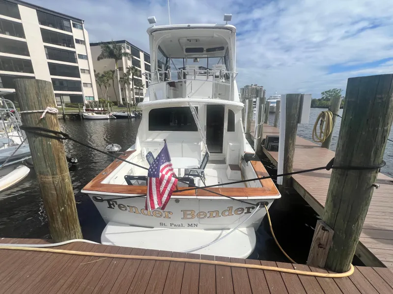 Slide: The Image of Ocean Yachts 1996 48 Super Sport docked, displaying American flag, sunny day. - 4