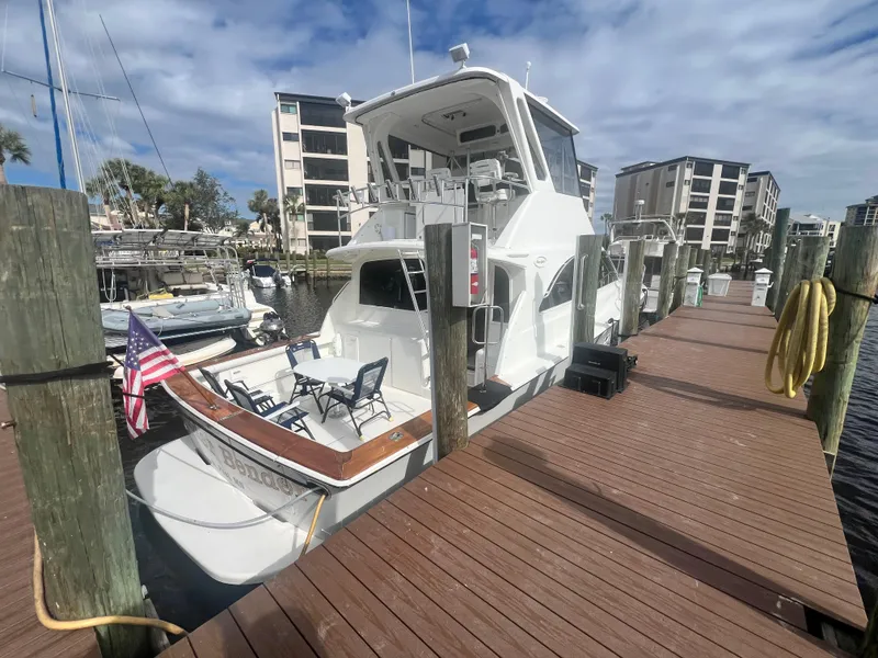 Slide: The Image of Ocean Yachts 1996 48 Super Sport docked at marina with American flag. - 5