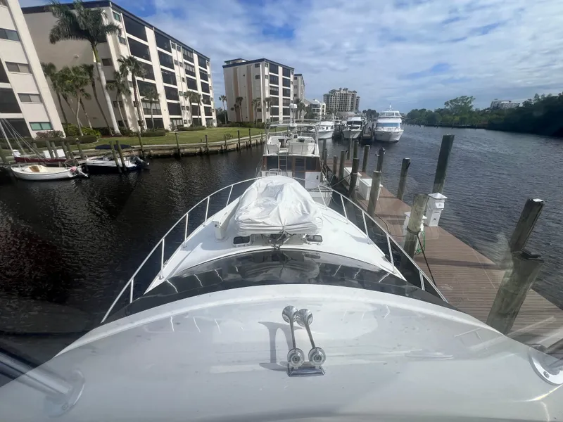 Slide: The Image of Ocean Yachts 1996 model 48 Super Sport docked at marina with waterfront buildings. - 9