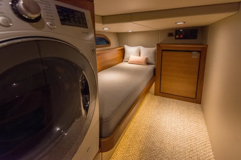 Slide: The Image of Cozy cabin interior of 2025 Eastbay EB44 with bed and laundry unit. - 12
