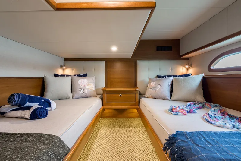 Slide: The Image of Luxurious Eastbay EB44 2026 yacht cabin with twin beds, elegant decor, and cozy lighting. - 15
