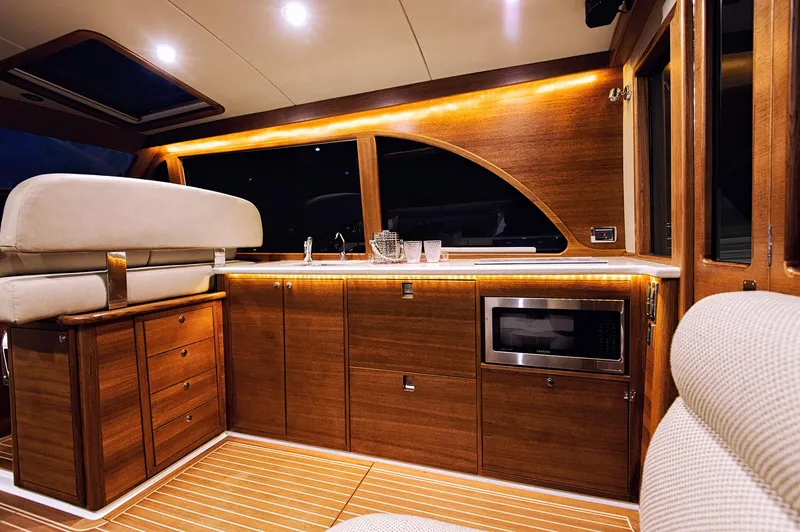 Slide: The Image of Luxurious interior of 2026 Eastbay EB44 yacht with wood cabinetry and modern amenities. - 16
