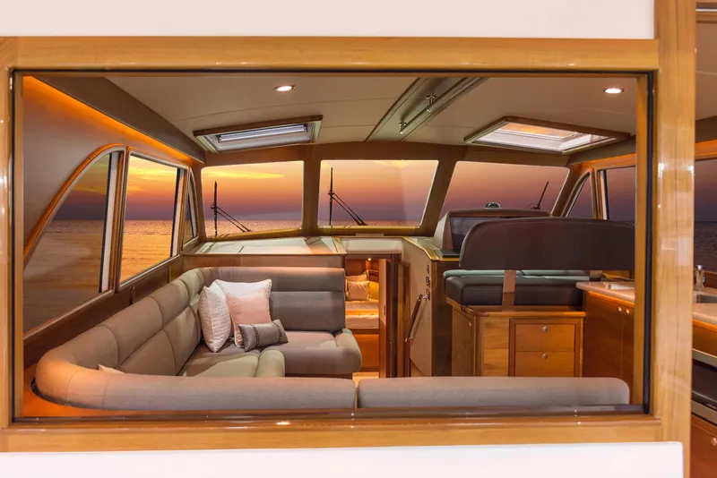 Slide: The Image of Luxurious interior of 2026 Eastbay EB44 yacht with sunset view through windows. - 17
