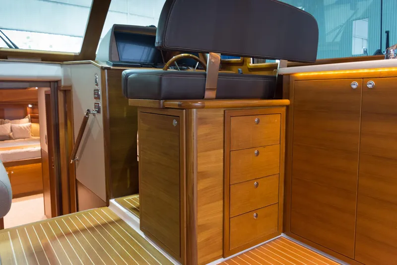 Slide: The Image of Luxurious Eastbay EB44 yacht interior, featuring elegant wood cabinetry and seating, 2026 model. - 18