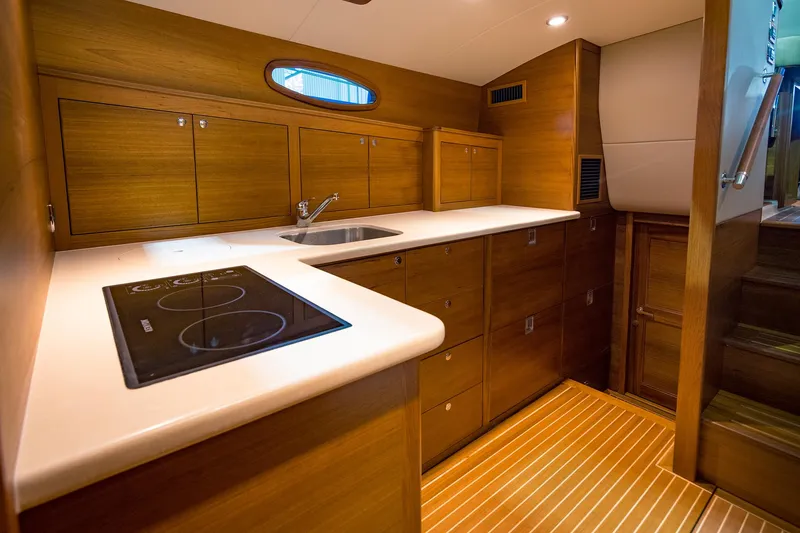 Slide: The Image of Modern kitchen in 2026 Eastbay EB44 yacht with wood cabinetry and sleek countertops. - 19
