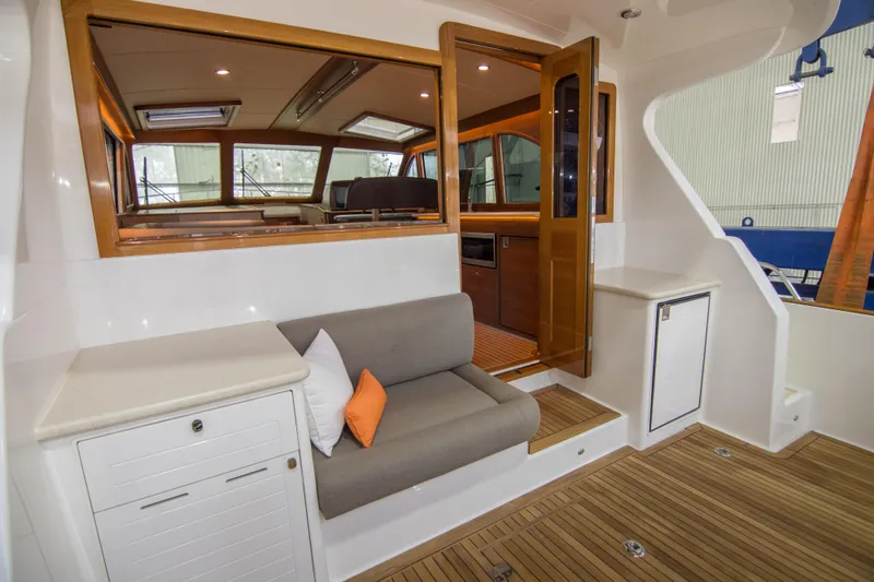 Slide: The Image of Interior of 2025 Eastbay EB44 yacht with wooden accents and comfortable seating. - 4