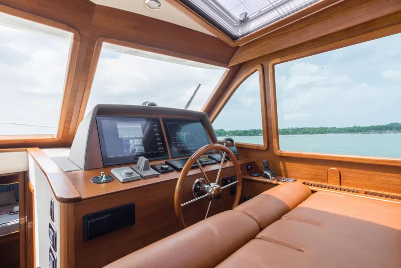 Slide: The Image of Interior of 2026 Eastbay EB44 yacht cockpit with modern navigation system and leather seating. - 5