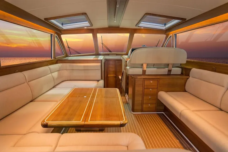 Slide: The Image of Luxurious interior of 2025 Eastbay EB44 yacht with sunset view through windows. - 6