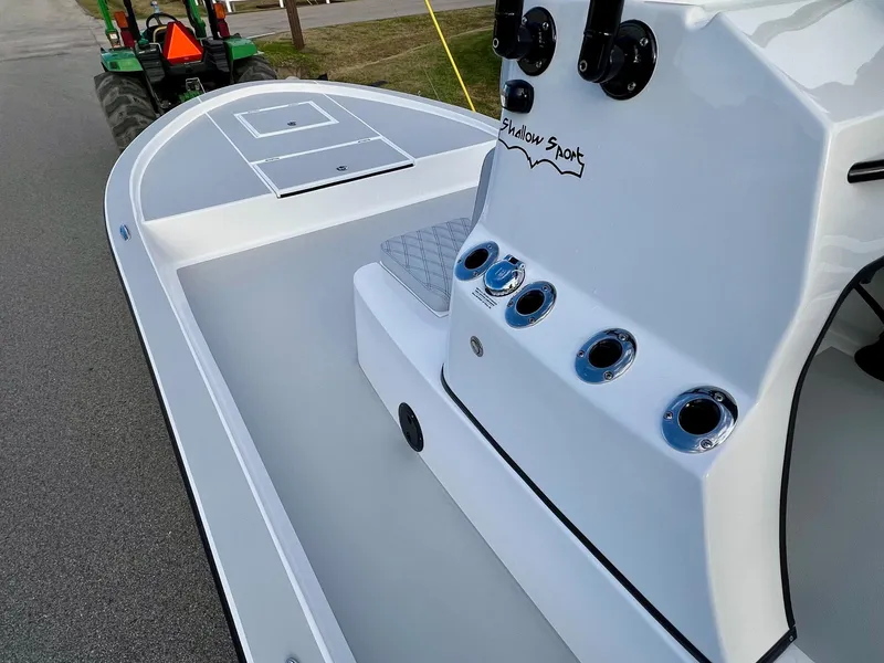Slide: The Image of 2025 Shallow Sport 24 Sport boat interior with console and rod holders. - 12