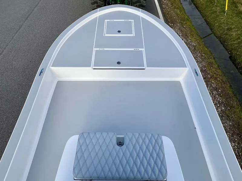 Slide: The Image of 2025 Shallow Sport 24 Sport boat deck with storage compartments and cushioned seating. - 13