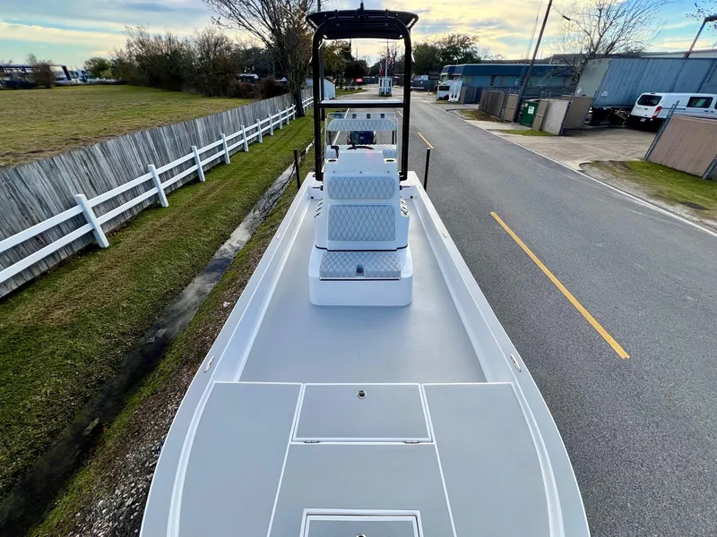 Slide: The Image of 2025 Shallow Sport 24 Sport boat on a road, showcasing sleek design and spacious deck. - 15