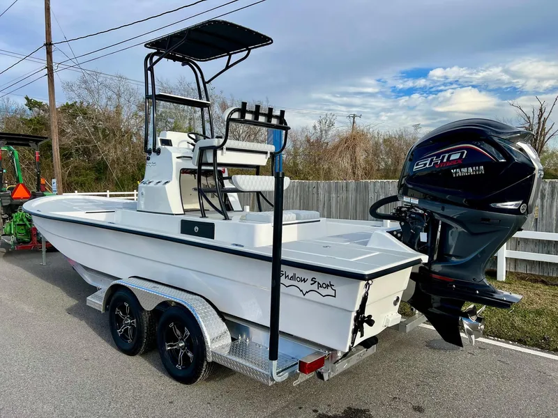 Slide: The Image of 2025 Shallow Sport 24 Sport boat with Yamaha engine on a trailer. - 2