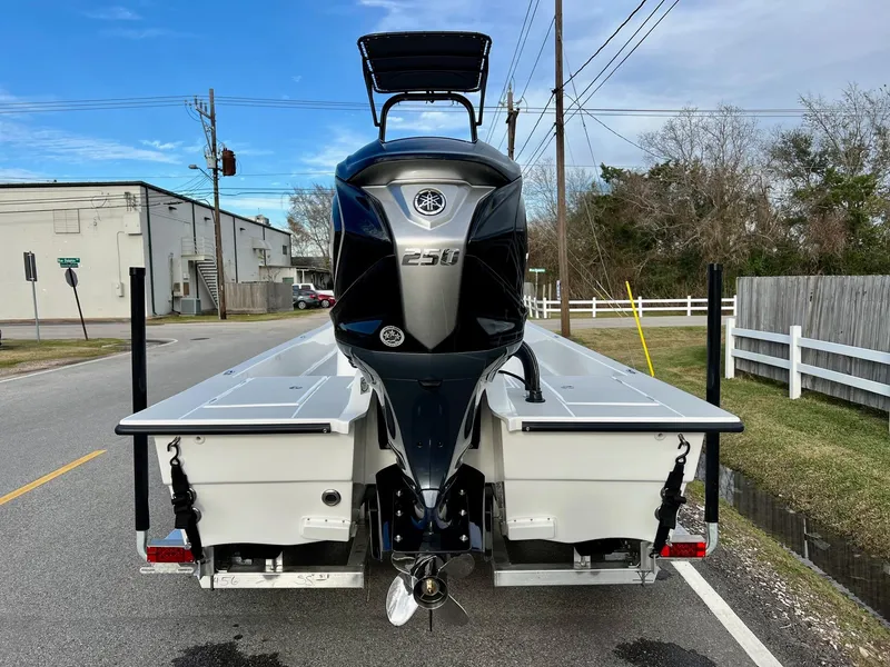 Slide: The Image of 2025 Shallow Sport 24 Sport boat with powerful outboard motor on a street. - 3