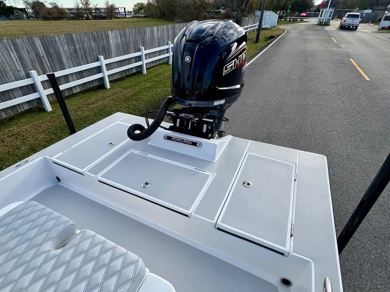 Slide: The Image of 2025 Shallow Sport 24 Sport boat with Yamaha engine on a road. - 7