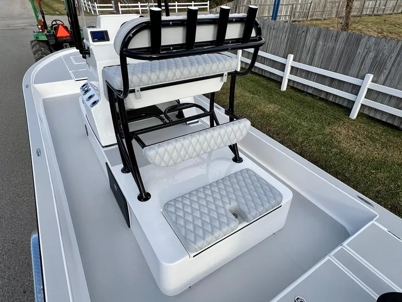 Slide: The Image of 2025 Shallow Sport 24 Sport boat interior with cushioned seating and console. - 8