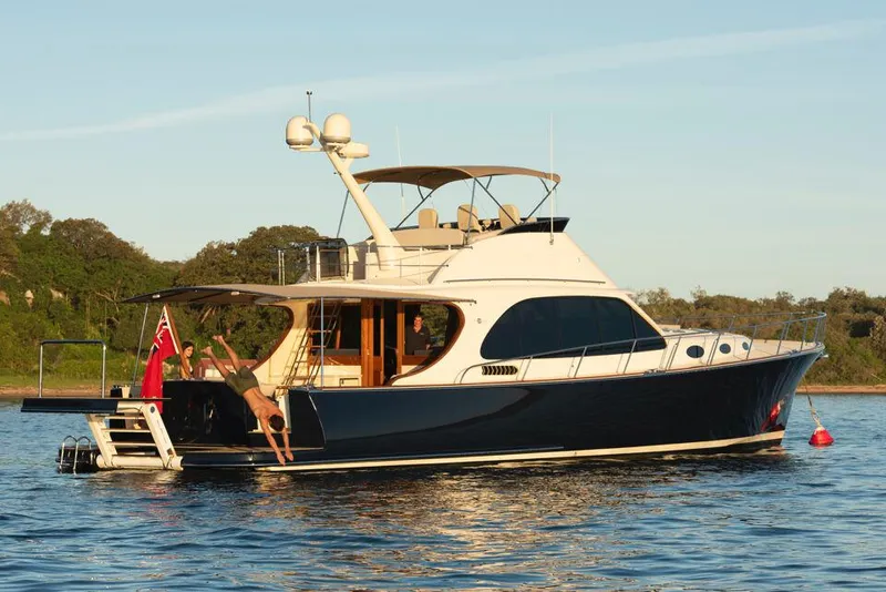 The Image of 2026 Palm Beach Motor Yachts PB65 on serene water with people enjoying the deck. - 0