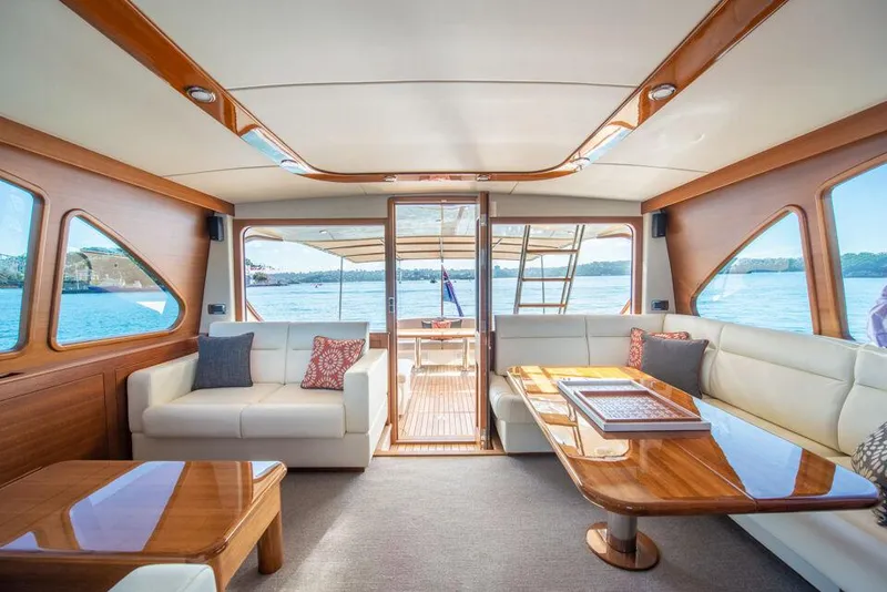 Slide: The Image of Luxurious interior of 2026 Palm Beach Motor Yachts PB65, featuring elegant seating and wood finishes. - 10