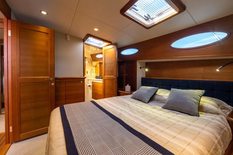 Slide: The Image of Luxurious cabin interior of 2026 Palm Beach Motor Yachts PB65 with elegant wood finishes. - 12