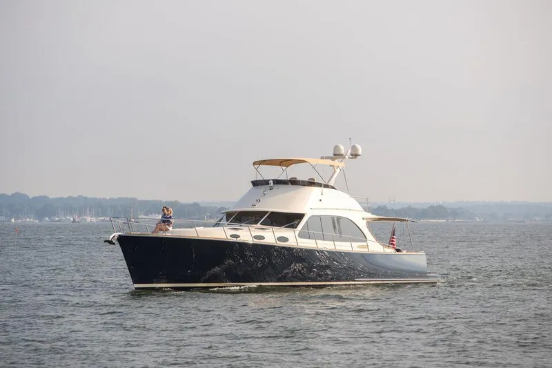 Slide: The Image of 2026 Palm Beach Motor Yachts PB65 cruising on open water. - 21