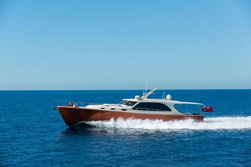 Slide: The Image of 2026 Palm Beach Motor Yachts PB65 cruising on open sea under clear blue sky. - 22