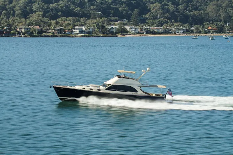 Slide: The Image of 2026 Palm Beach Motor Yachts PB65 cruising on a serene coastal waterway. - 25