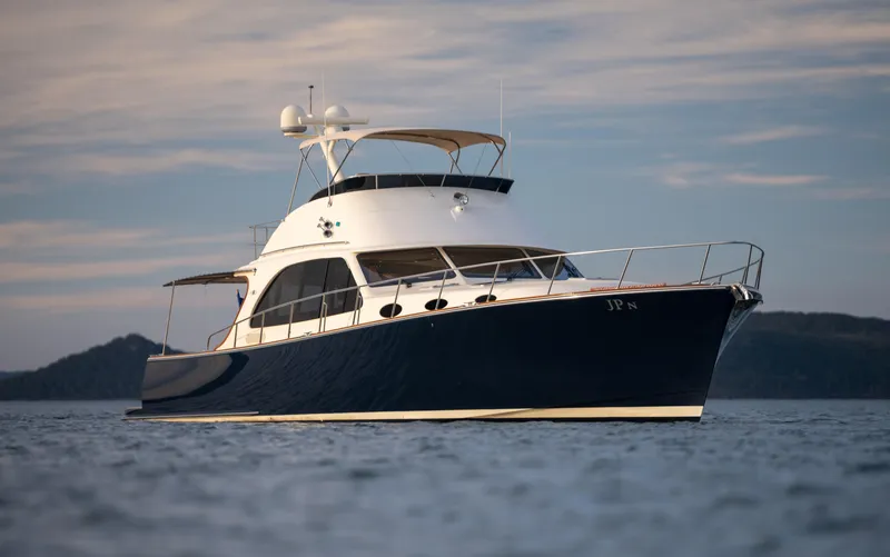 Slide: The Image of 2026 Palm Beach Motor Yachts PB65 cruising on calm waters at sunset. - 29