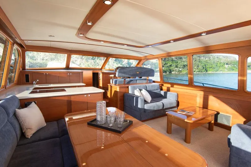 Slide: The Image of Luxurious interior of 2026 Palm Beach Motor Yachts PB65 with elegant wood finishes and plush seating. - 6