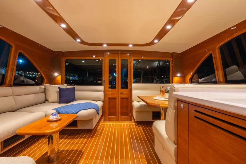 Slide: The Image of Luxurious interior of 2026 Palm Beach Motor Yachts PB65 with elegant wood finishes and cozy seating. - 7