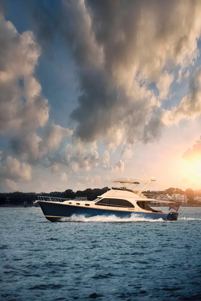 Slide: The Image of 2026 Palm Beach Motor Yachts PB65 cruising at sunset on open water. - 28