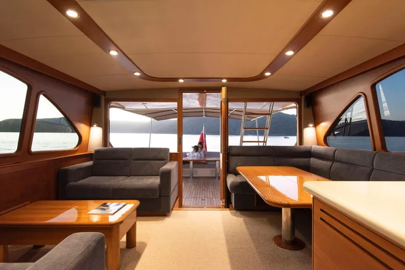 Slide: The Image of Luxurious interior of 2026 Palm Beach Motor Yachts PB65, featuring elegant seating and wooden accents. - 8