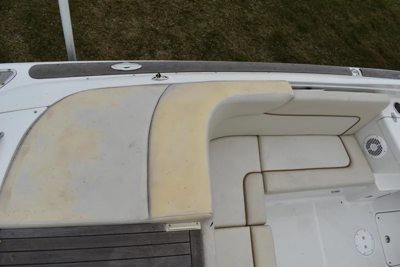 Slide: The Image of 2009 Chris-Craft Corsair 25 boat seating area with white and beige upholstery. - 11