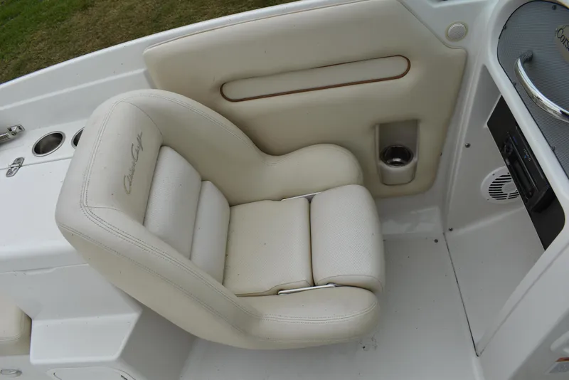 Slide: The Image of 2009 Chris-Craft Corsair 25 boat interior with white cushioned seating. - 14