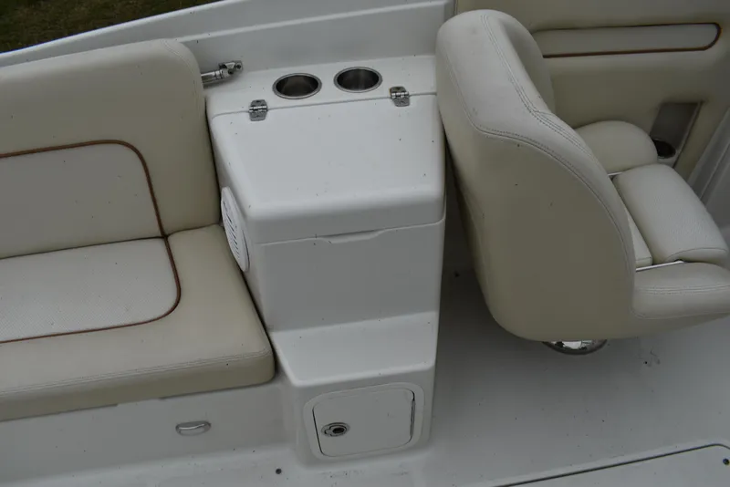 Slide: The Image of 2009 Chris-Craft Corsair 25 boat interior with beige seating and cup holders. - 15