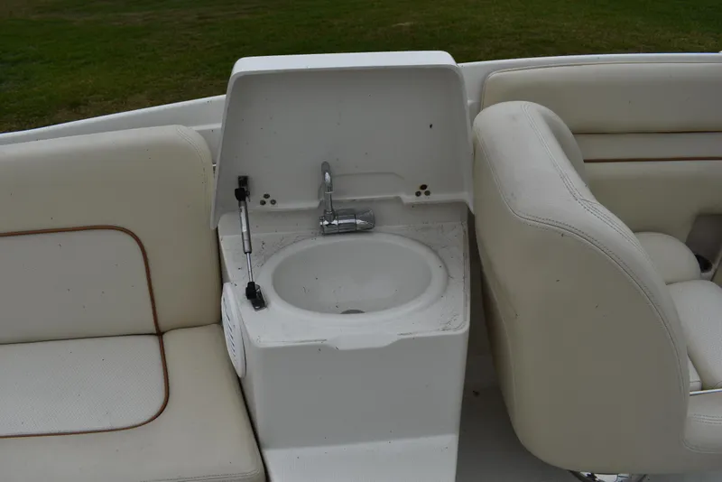 Slide: The Image of 2009 Chris-Craft Corsair 25 boat interior with sink and seating area. - 16