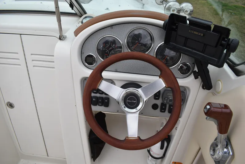 Slide: The Image of 2009 Chris-Craft Corsair 25 dashboard with steering wheel and instrument panel. - 21