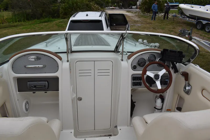 Slide: The Image of 2009 Chris-Craft Corsair 25 boat interior with steering wheel and dashboard. - 23