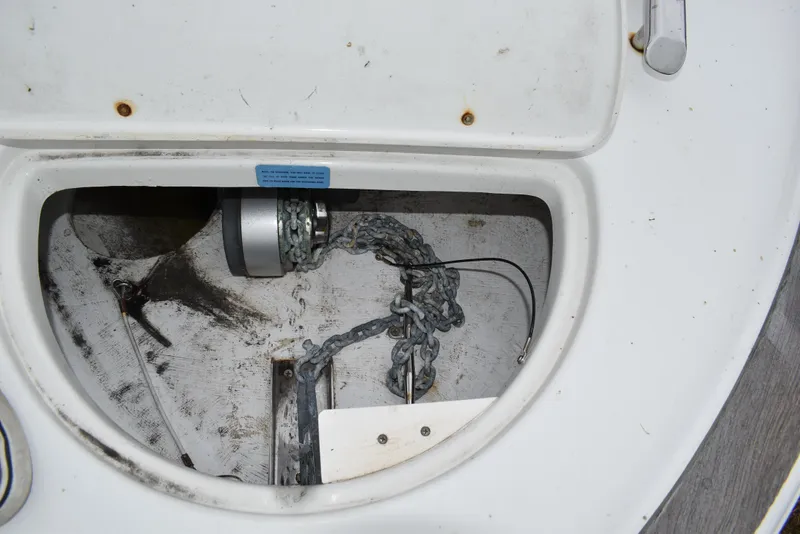 Slide: The Image of Anchor compartment of 2009 Chris-Craft Corsair 25 boat, showing chain and winch. - 28