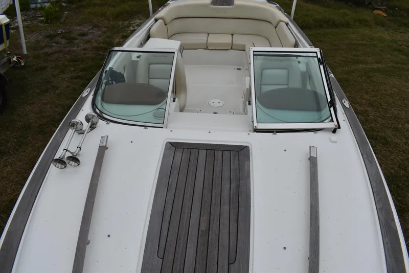Slide: The Image of 2009 Chris-Craft Corsair 25 boat with open windshield and cushioned seating. - 29