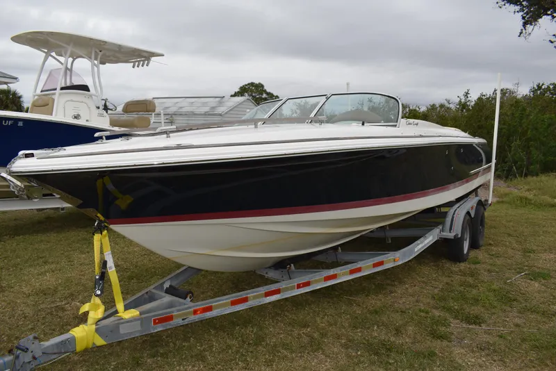 Slide: The Image of 2009 Chris-Craft Corsair 25 boat on trailer, parked on grass. - 3