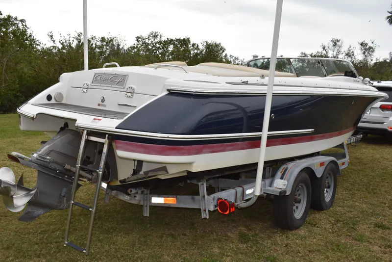 Slide: The Image of 2009 Chris-Craft Corsair 25 boat on trailer, parked on grass. - 5