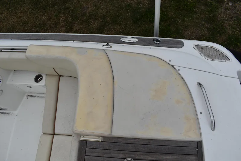 Slide: The Image of 2009 Chris-Craft Corsair 25 boat interior with beige seating and wooden accents. - 9