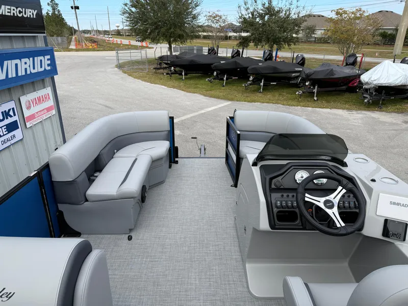 Slide: The Image of 2025 Bentley Pontoons 20 Legacy interior with modern seating and steering console. - 11