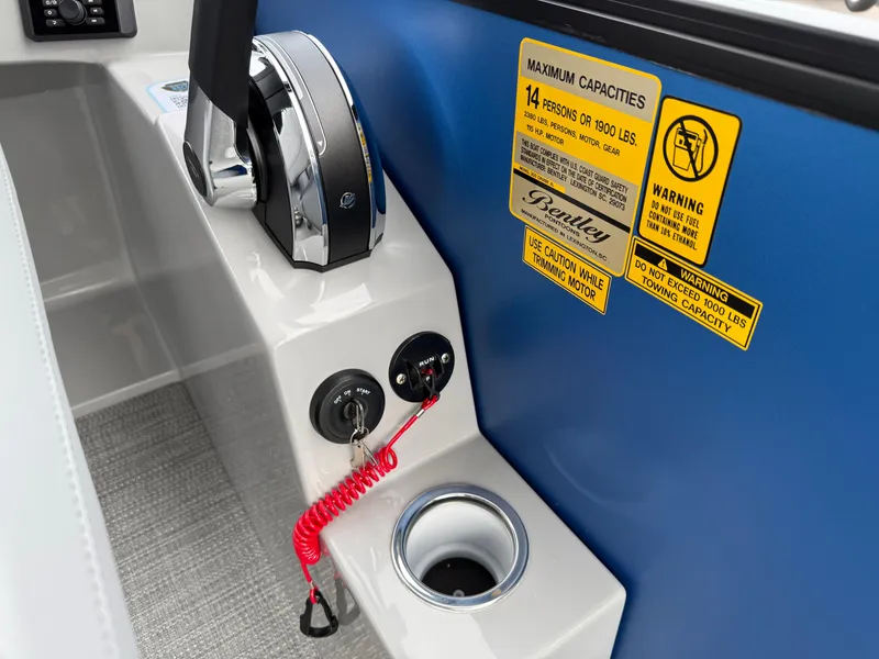 Slide: The Image of Control panel of 2025 Bentley Pontoons 20 Legacy with safety labels and throttle. - 15