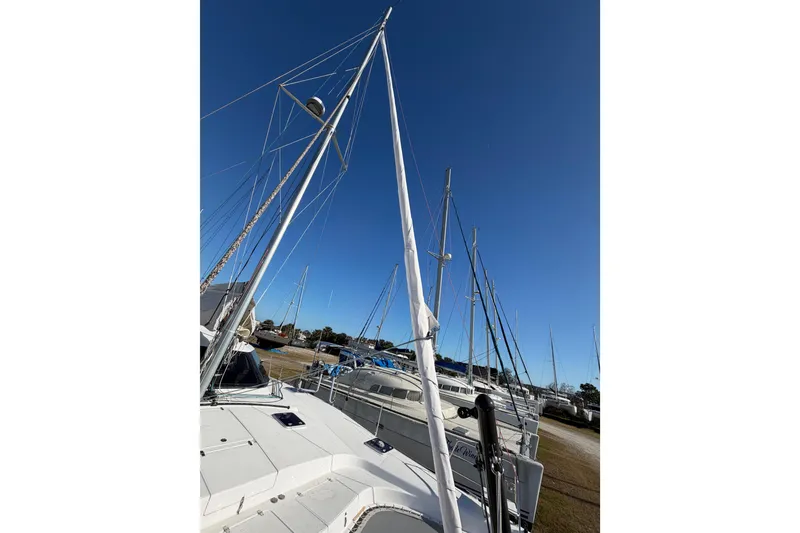 Slide: The Image of 2020 Seawind 1260 catamaran with mast, docked under clear blue sky. - 104