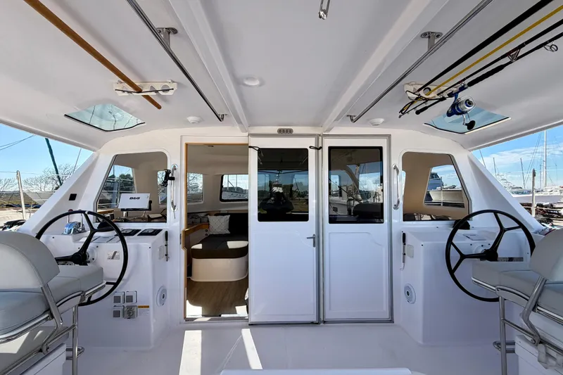 Slide: The Image of 2020 Seawind 1260 catamaran cockpit with dual steering wheels and modern interior. - 106
